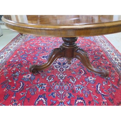 77 - A Victorian walnut tilt top breakfast / dining table on carved tripod base, 72cm tall x 133cm diamet... 