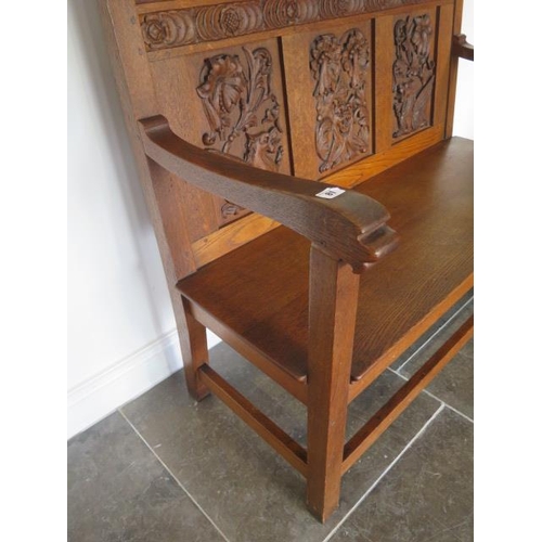 81 - A well carved oak bench hall settle, dated 1928, 106cm tall x 113cm x 55cm, in good condition with a... 