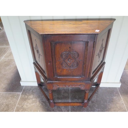 A carved oak cupboard with a single door, back panel missing, 79cm wide