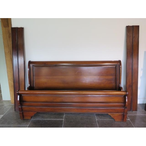 15 - A modern mahogany 6' sleigh bed with a two piece MDF board base