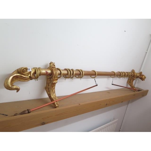 17 - A decorative gilt and red curtain pole, 198cm long