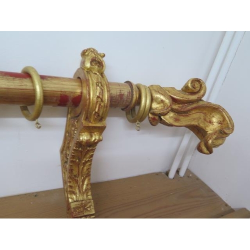 17 - A decorative gilt and red curtain pole, 198cm long