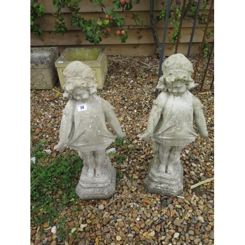 28 - A pair of stone effect statues, 62cm tall