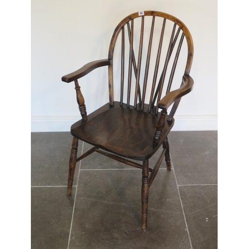 54 - An early 20th century Windsor stickback elbow chair in good polished condition