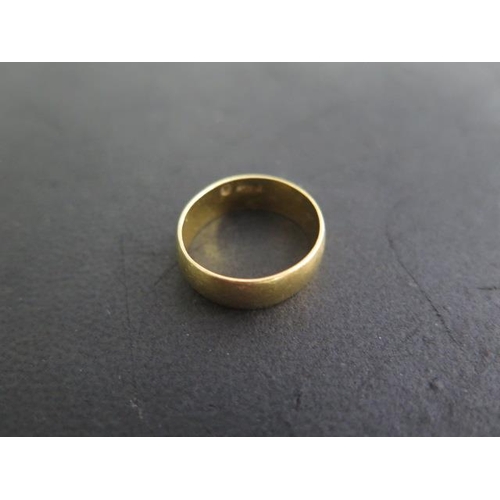 A 22ct yellow gold hallmarked band ring, size N, approx 5.8 grams, some usage marks but generally good