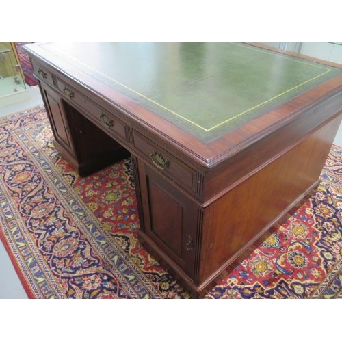 75 - An Edwardian mahogany partners twin pedestal desk with a leather inset top and nine drawers with thr... 