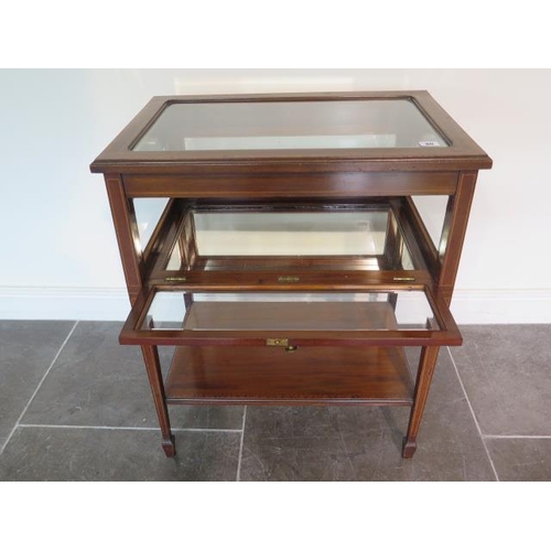 80 - An Edwardian inlaid mahogany bijouterie display table with a drop down door, in generally good condi... 