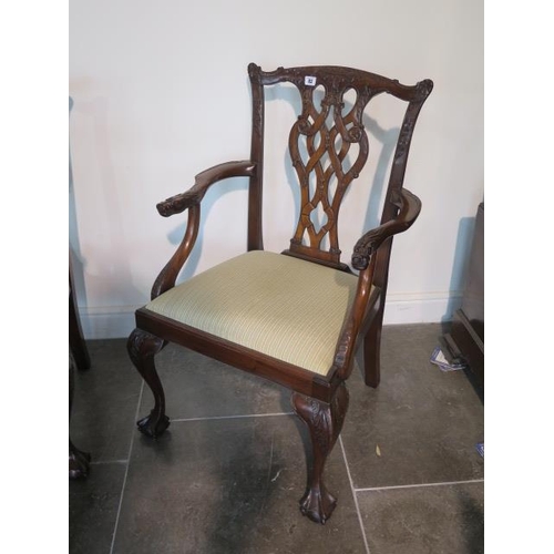 82 - A set of twelve Georgian style dining chairs including two carvers with stripped seats on ball and c... 