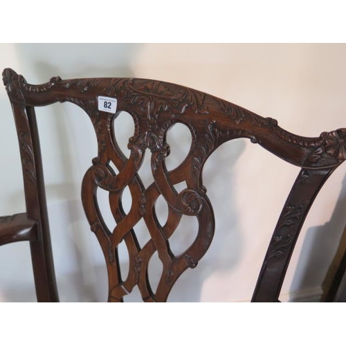 82 - A set of twelve Georgian style dining chairs including two carvers with stripped seats on ball and c... 