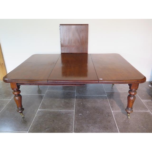 83 - A 19th century mahogany pullout dining table with two leaves on turned carved legs, 71cm tall x 126c... 