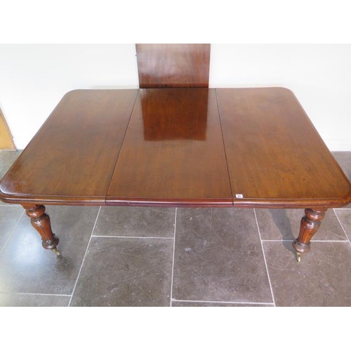 83 - A 19th century mahogany pullout dining table with two leaves on turned carved legs, 71cm tall x 126c... 