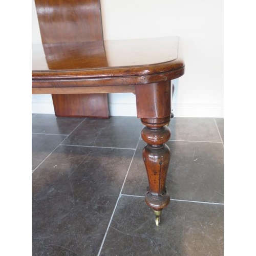 83 - A 19th century mahogany pullout dining table with two leaves on turned carved legs, 71cm tall x 126c... 