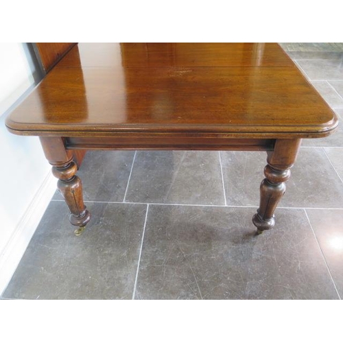 83 - A 19th century mahogany pullout dining table with two leaves on turned carved legs, 71cm tall x 126c... 