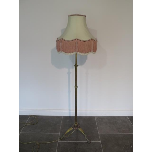 84 - A brass adjustable standard lamp with shade extends to 211cm, in working order