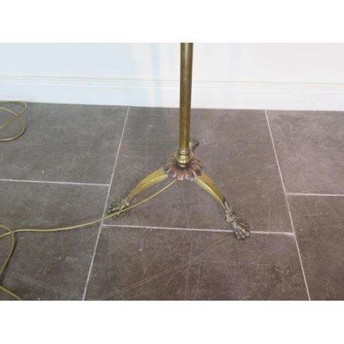 84 - A brass adjustable standard lamp with shade extends to 211cm, in working order