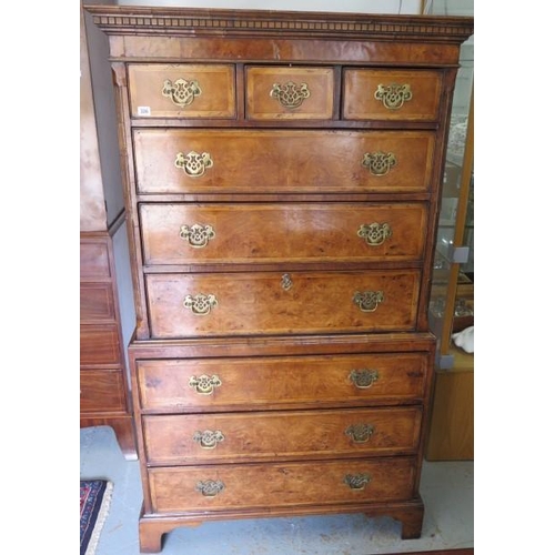 86 - An antique style walnut chest on chest with three small drawers over six long drawers, one with a fi... 