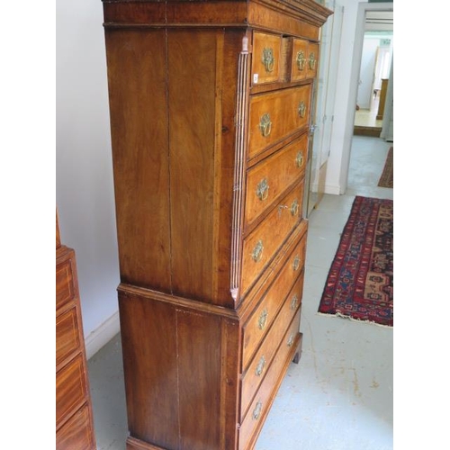 86 - An antique style walnut chest on chest with three small drawers over six long drawers, one with a fi... 