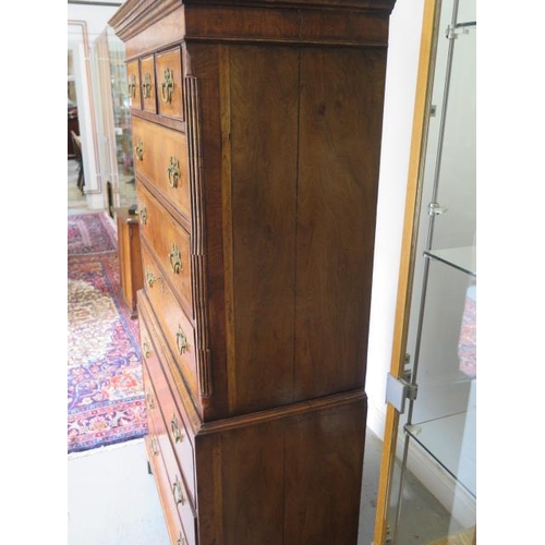 86 - An antique style walnut chest on chest with three small drawers over six long drawers, one with a fi... 