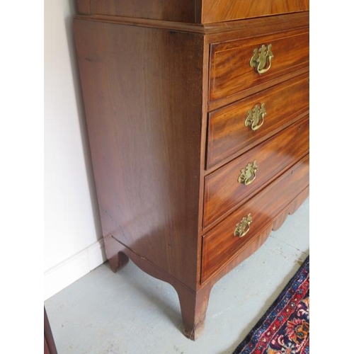 87 - A Georgian mahogany linen press with two door top enclosing a slide and a shelf above a four drawer ... 