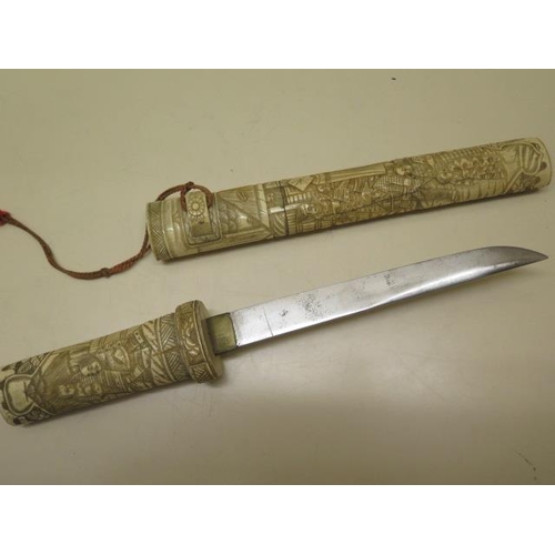 944 - A 20th century carved bone Japanese dagger, 39cm long, generally good ,roundal missing to one end, c... 