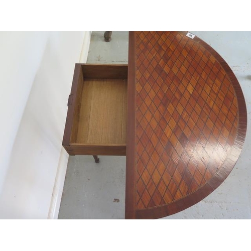 66 - An Edwardian parquetry fold over demi-lune card table on square tapering legs, 75cm tall x 80cm, gen... 