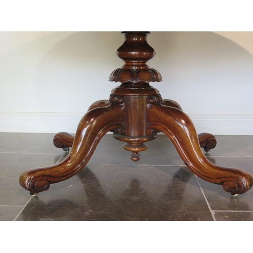 51 - A good 19th century rosewood breakfast table with an oval 152cm x 120cm top on a carved quatrefoil s... 