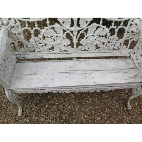 17 - A good cast iron acorn and leaf decorated garden bench with leopard head arms, 95cm tall x 150cm x 6... 