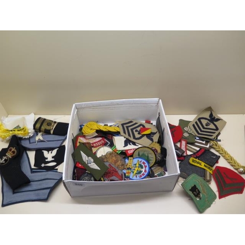 944 - A collection of military cloth badges etc.