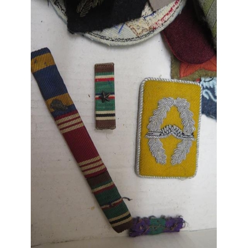 944 - A collection of military cloth badges etc.