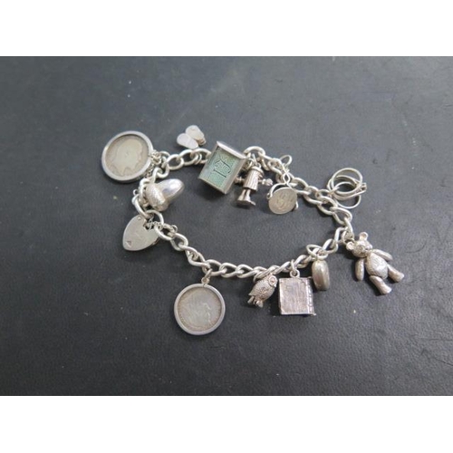 614 - A silver charm bracelet and ingot on chain, total approx 79 grams