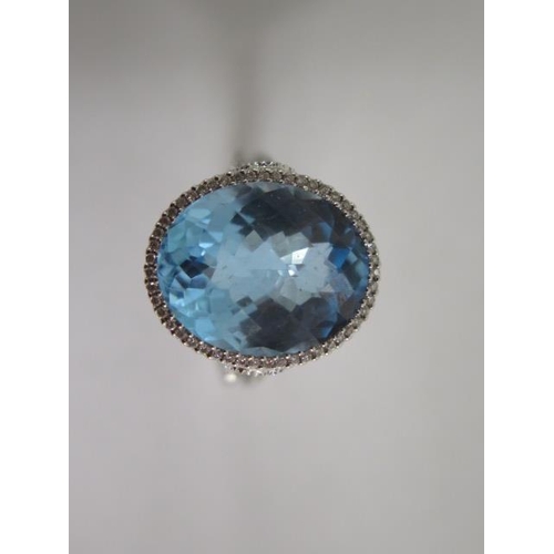 A hallmarked 18ct white gold oval topaz and diamond ring with diamond shoulders, approx 1.0ct of diamonds, size N, head approx 18mm x 15mm, in good condition