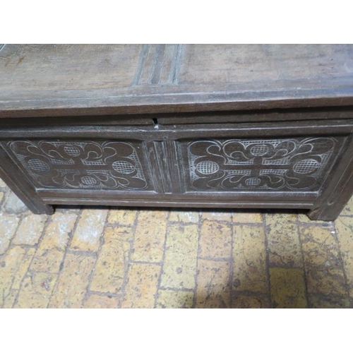 88 - An 18th century oak coffer with a carved two panel front, 52cm tall x 108cm x 42cm