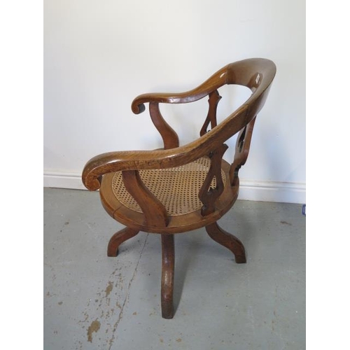 89 - A Victorian oak swivel desk chair with a cane seat having a brass plaque - This oak chair was made o... 