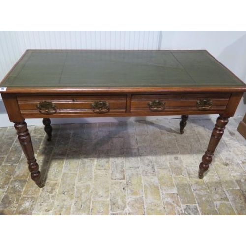 96 - A Victorian writing table / desk with a tooled green leather top with two frieze drawers standing on... 