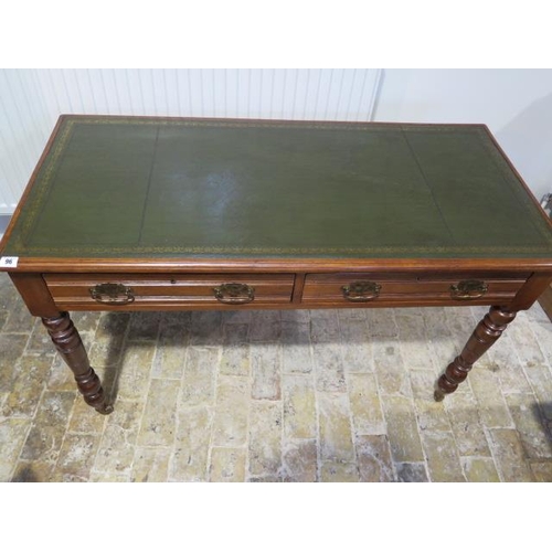 96 - A Victorian writing table / desk with a tooled green leather top with two frieze drawers standing on... 