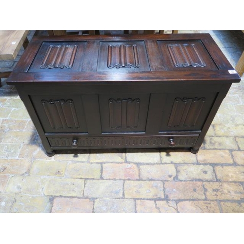 98 - An early 20th century oak coffer the top and front with three linen fold panels, a lower frieze draw... 