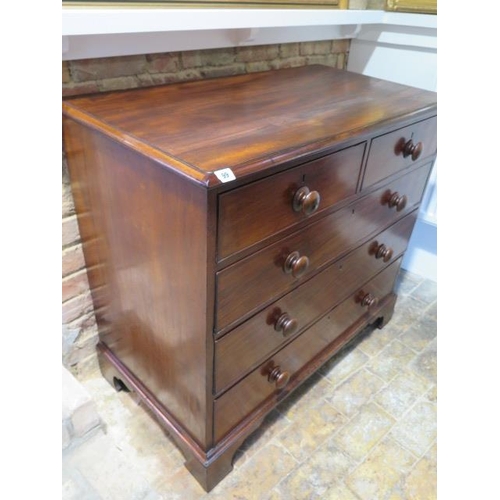 99 - A Georgian mahogany chest of two over three graduated and cockbeaded drawers, with bun handles stand... 