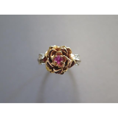 A hallmarked Elizabeth of Glamis Rose ring, a jewelled ring crafted of 2 shades of 14ct gold set with 8 sparkling diamonds and a single ruby, inspired by Rose Benford, number 383 of 3,500, ring size S, approx 7.5 grams, in good condition with certificate