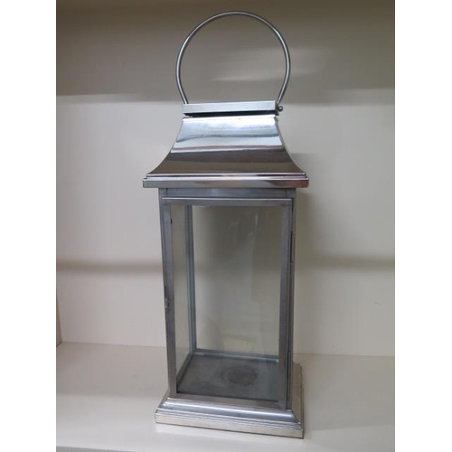 12 - A large stainless steel lantern, 83cm tall x 30cm x 22cm
