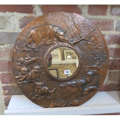 15 - A copper relief decorated lion pride circular mirror, 52cm diameter
