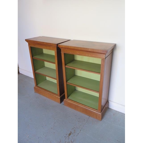 26 - A pair of new walnut bookcases with adjustable shelves and painted interior, made by a local craftsm... 