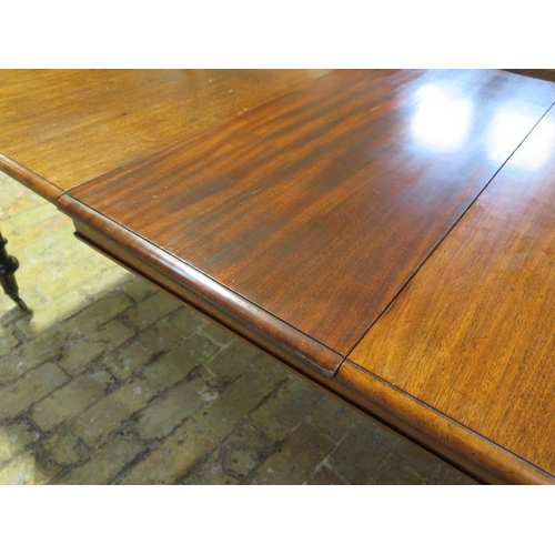 60 - A 19th mahogany pullout dining table with one associated leaf on turned inverted tulip carved legs, ... 