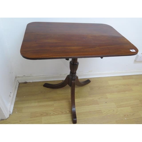 64 - A 19th century mahogany tilt top table on a turned column and splayed tripod base, 70cm tall x 54cm ... 