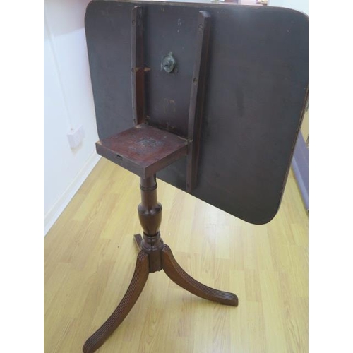 64 - A 19th century mahogany tilt top table on a turned column and splayed tripod base, 70cm tall x 54cm ... 
