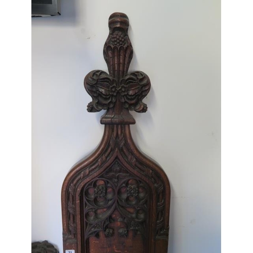 71 - An antique part carving of a rampant lion, 71cm tall and a carved oak pew end 158cm tall x 38cm wide... 