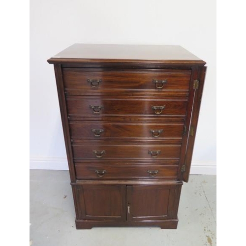 80 - An Edwardian mahogany Wellington chest cabinet with 5 drawer above 2 cupboard doors with key, 109cm ... 