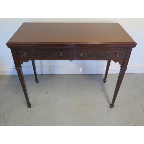 85 - An Edwardian side / card table with 2 frieze drawers faced with blind fretwork brass knob handles, t... 