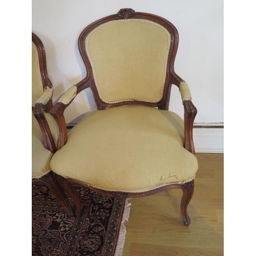 103 - A pair of carved beechwood upholstered elbow chairs, 85cm tall x 57cm wide