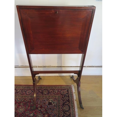 108 - A 19th century mahogany drop flap writing / reading stand on twin supports with brass caps and caste... 