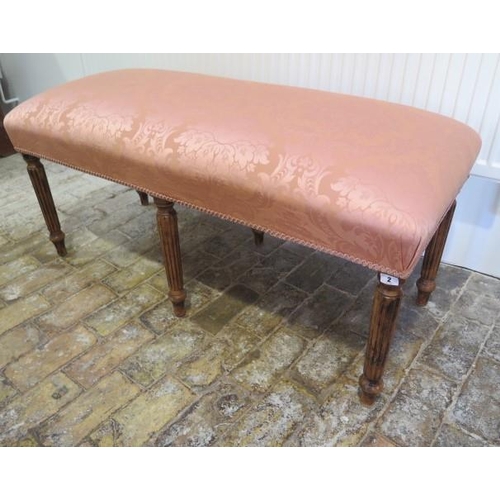 2 - An upholstered window stool on six turned reeded legs, 54cm tall x 116cm x 49cm, in good condition